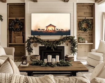 May include: A living room with a white fireplace and a TV playing a Christmas nativity scene. The room is decorated with greenery and candles. There are two white couches and a coffee table with a wooden top.