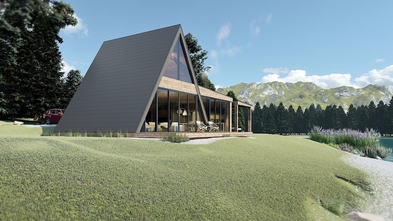 Puede incluir: Una casa moderna de forma triangular con grandes ventanales y una terraza de madera. La casa est&aacute; situada en una colina cubierta de hierba con vistas a un lago y monta&ntilde;as en la distancia.