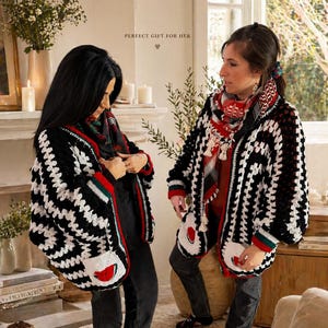 May include: Two people wearing black and white crochet cardigans with red and green trim and watermelon pocket designs. The cardigans are open, revealing black shirts and scarves. The text "PERFECT GIFT FOR HER" is visible.