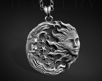 May include: A silver pendant necklace featuring a detailed, circular design with two faces, one male and one female, surrounded by stars. The pendant is attached to a silver chain.