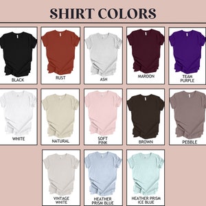 May include: A chart showing different colors of t-shirts. The colors include black, rust, ash, maroon, team purple, white, natural, soft pink, brown, pebble, vintage white, heather prism blue, and heather prism ice blue.