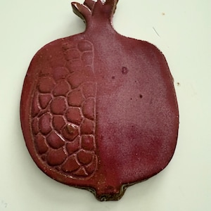 Jerusalem and pomegranate hanging ceramic pieces.