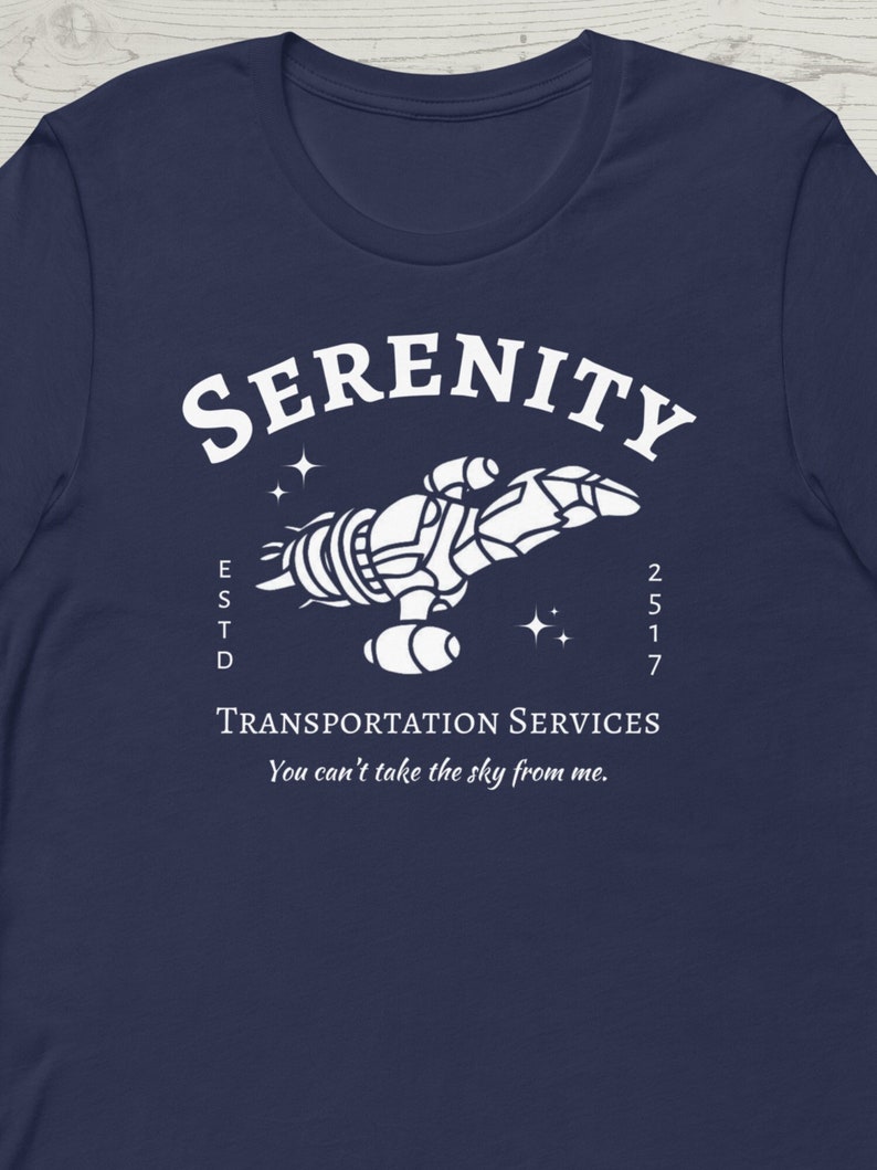 May include: A navy blue t-shirt with a white graphic of a spaceship with the text "SERENITY ESTD 2517 TRANSPORTATION SERVICES You can't take the sky from me."