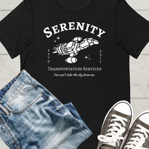 May include: Black t-shirt with a white graphic of a spaceship with the text "SERENITY ESTD 2517 TRANSPORTATION SERVICES You can't take the sky from me."