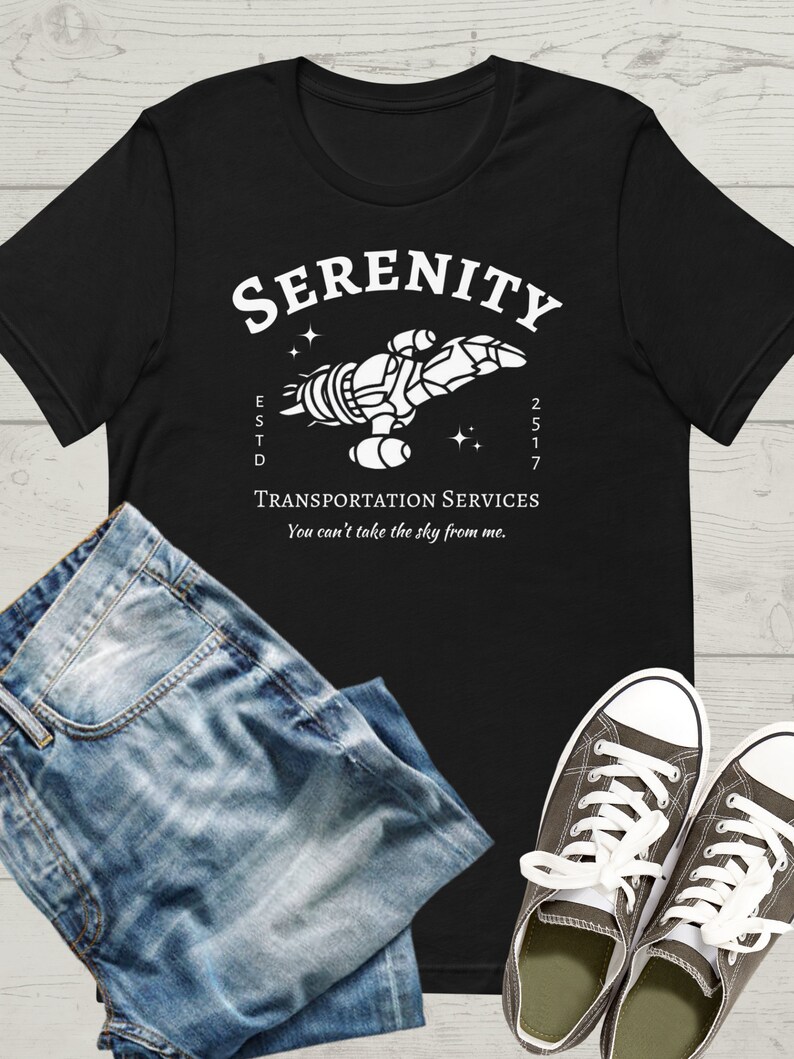 May include: Black t-shirt with a white graphic of a spaceship with the text "SERENITY ESTD 2517 TRANSPORTATION SERVICES You can't take the sky from me."