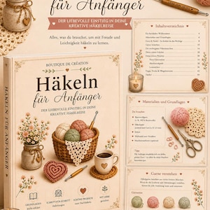 Può includere: Un libro di istruzioni con copertina rigida intitolato Häkeln für Anfänger, raffigurante un cestino di gomitoli di lana, un uncinetto, un sottobicchiere a forma di cuore e illustrazioni floreali. La copertina include testo, icone e sfondo beige.