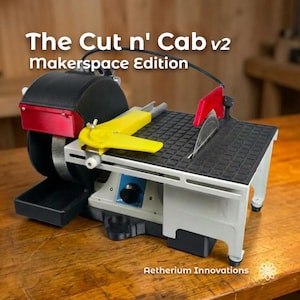 May include: The Cut n' Cab v2 Makerspace Edition is a compact lapidary machine featuring a black housing, a circular saw blade with a red guard, a yellow adjustable miter gauge, and a grey work surface. The unit includes a black grinding wheel.