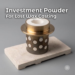 May include: A cylindrical metal casting flask with a brass-colored rim and a dark, weathered body featuring a pattern of white circular spots. The text Investment Powder For Lost Wax Casting is displayed above the object in white lettering.