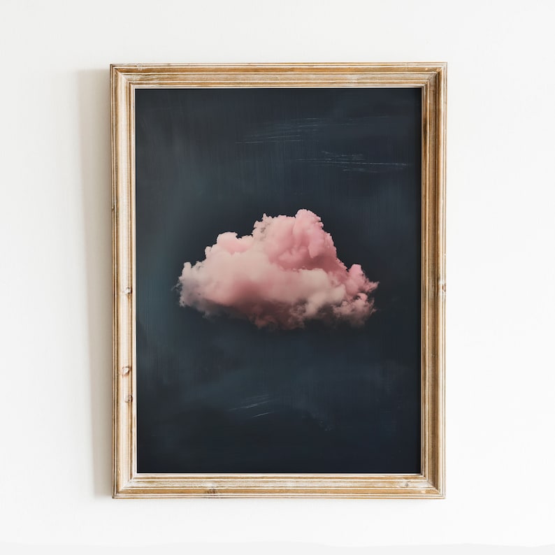 May include: A framed print of a single pink cloud against a dark blue background.