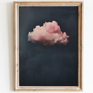 May include: A framed print of a single pink cloud against a dark blue background.