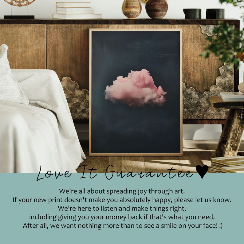 May include: A framed print of a pink cloud against a dark blue background. The print is in a gold frame and is hanging on a wall. The text "Love It Guarantee" is written in white letters on a light blue background below the print. The text reads: "We're all about spreading joy through art. If your new print doesn't make you absolutely happy, please let us know. We're here to listen and make things right, including giving you your money back if that's what you need. After all, we want nothing more than to see a smile on your face! :)"