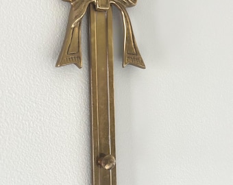 Vintage Brass Bow Wall hanging rack for pictures or plates.