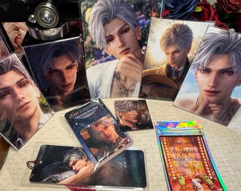 May include: A collection of Love and Deepspace merchandise featuring multiple prints, a bookmark, and a sticker pack. Each item displays a digital illustration of a character with silver hair. The sticker pack is labeled Love and Deepspace Plushie Stickers Ver. 2.