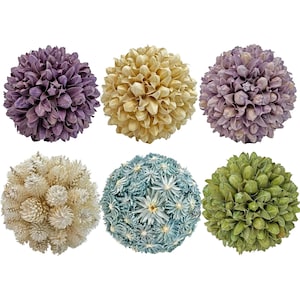 May include: Six decorative spheres in various colors. The spheres are made of dried flowers or similar materials. Colors include purple, beige, light purple, off-white, blue-green, and green. The spheres are arranged in two rows of three.