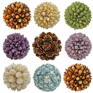 May include: Nine decorative spheres in various colors, including brown, beige, green, purple, and blue. The spheres are made of natural materials, such as dried flowers and pinecones, and are arranged in a grid pattern against a white background.