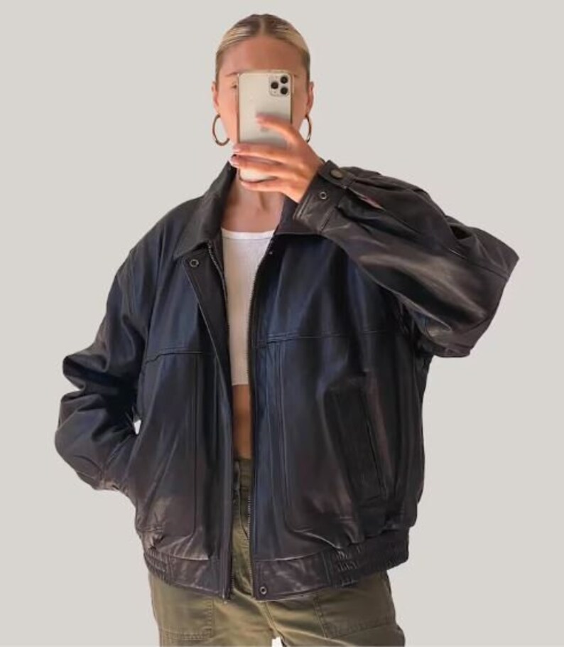 May include: A black leather bomber jacket with a zipper closure and a stand-up collar.