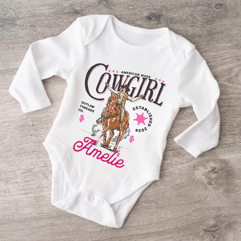 Yeehaw! This personalized "Pink Cowgirl Toddler Shirt" is perfect for a Rodeo Birthday or Western-themed party. Add the name and customize it—order yours today!