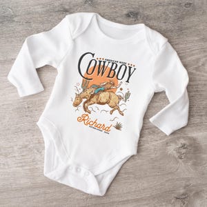 Personalized Cowboy Birthday Shirt – For Your Little Sheriff’s Big Day! 🎉 Yeehaw! Celebrate your little cowboy’s special day with this adorable personalized shirt. Perfect for wild west parties and unforgettable photos. 💛 Make their birthday special—grab yours now and let the adventure begin! 🐴✨ Cowboy Toddler Shirt! It's perfect for capturing memories together!