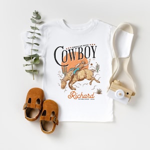 Personalized Cowboy Birthday Shirt – For Your Little Sheriff’s Big Day! 🎉

Yeehaw! Celebrate your little cowboy’s special day with this adorable personalized shirt. Perfect for wild west parties and unforgettable photos. 💛

Make their birthday special—grab yours now and let the adventure begin! 🐴✨ Cowboy Toddler Shirt! It's perfect for capturing memories together!