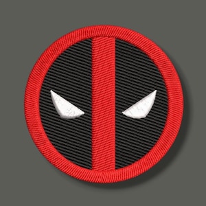 May include: A circular embroidered patch featuring a red border and a central vertical red stripe against a black background. Two white, triangular, eye-shaped elements are positioned symmetrically on either side of the central red stripe.