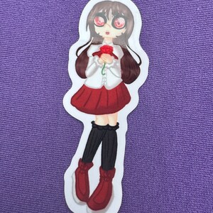 以下が含まれることがあります： 白いシャツ、赤いスカート、黒いストッキング、赤い靴を履いた、長い茶色の髪の漫画の女の子のステッカー。彼女は赤いバラを手に持ち、黒い瞳の大きな赤い目をしています。