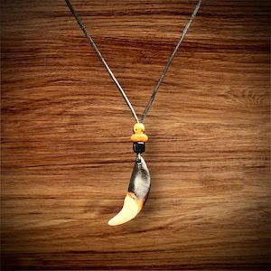 Wolf tooth necklace. Leather cord, brass and trade beads.