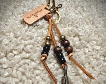 Handmade laced brass key clip or Japanese fish hook. Assorted beads.  Feather pendant.