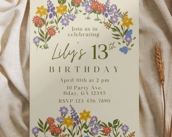 May include: A floral-themed birthday invitation for Lily's 13th birthday. The invitation features a wreath of colourful flowers and leaves, with the text "Join us in celebrating Lily's 13th Birthday" in a green font. The invitation also includes the date, time, and location of the party, as well as an RSVP number.