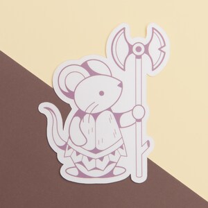 May include: A sticker featuring a cartoon mouse character in a purple and white color scheme. The mouse is holding a large axe. The background is a diagonal split of brown and light yellow.
