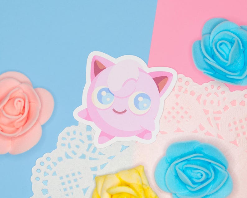 A kawaii vinyl sticker displayed on a pink and blue background.