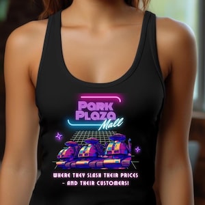 May include: Black tank top featuring a retro design with the text "Park Plaza Mall" in neon pink and blue. Below the text are three futuristic vehicles. The bottom of the tank top reads "WHERE THEY SLASH THEIR PRICES - AND THEIR CUSTOMERS!"