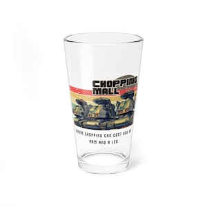 May include: A clear pint glass featuring a retro design with the words "SHOPPING MALL" and a graphic of three robot-like vehicles. The text "WHERE SHOPPING CAN COST YOU AN ARM AND A LEG" is also included.