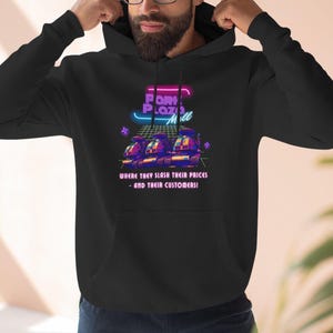 May include: Black hooded sweatshirt with a front graphic. The graphic features the text "Port Plaza Mall" in neon colors, along with an image of three vehicles and the phrase "Where they slash their prices - and their customers!"