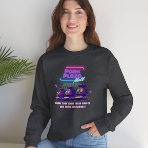 May include: Dark gray sweatshirt with a neon graphic that reads "Park Plaza Mall" above a retro image of cash registers. The text below reads "Where they slash their prices - and their customers!"