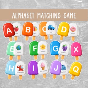 Op de afbeelding: Alphabet-matching game met kleurrijke, lolly-vormige kaarten met letters A tot en met Q en bijbehorende afbeeldingen. De afbeeldingen omvatten een appel, een bal, een auto, een donut, de aarde, een bloem, druiven, een helikopter, ijs, een jas en een vraagteken.