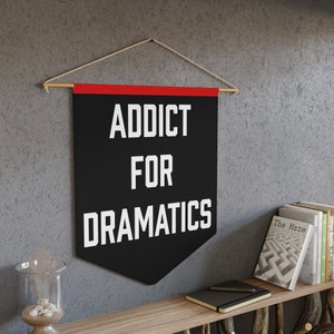 May include: Black and red fabric banner with white text that reads "Addict for Dramatics".