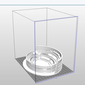 May include: A 3D-printed model of the Colosseum, a famous Roman amphitheater. The white structure is partially enclosed within a transparent box, showcasing the architectural details of the ancient landmark. The model sits on a gray surface.