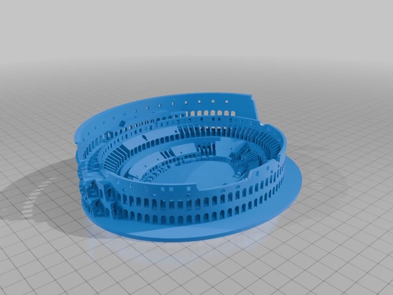 May include: A light blue 3D model of the Colosseum, a Roman amphitheater. The model is a detailed representation of the historic structure, showcasing its architectural features. The model is made of a solid material and is set against a neutral background.