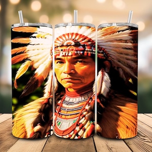 May include: Three stainless steel tumblers featuring a Native American portrait. The design shows a man in a feathered headdress and traditional clothing. Each tumbler has a straw and a detailed, colourful print.
