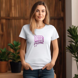 May include: White t-shirt with a crew neck featuring the text "DATA nerd" in a purple and white design. The graphic is in a rectangular shape with a star below the text. The shirt is made of a soft material.