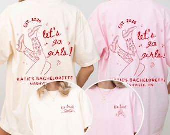 May include: Cream and pink t-shirts with red text and graphics. The back of the shirts say "Let's go girls!" with a graphic of cowboy boots and the text "Katie's Bachelorette Nashville, TN". The front of the cream shirt says "the bride". The front of the pink shirt says "the back".