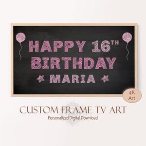 May include: A black chalkboard with a pink chalk inscription that reads "Happy 16th Birthday Maria". Two pink balloons are drawn on either side of the text. The chalkboard is framed in wood.