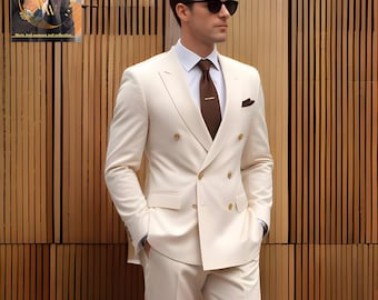 May include: A cream-colored double-breasted suit with gold buttons, a white dress shirt, and a brown tie. The suit has a pocket square and is worn with sunglasses. The background is a wooden wall.