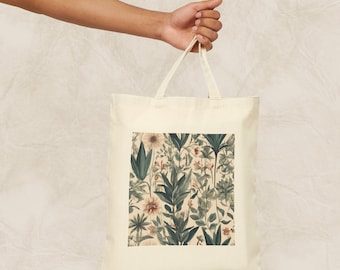 Op de afbeelding: Een beige canvas tote bag met een bloemenprint met roze en groene bloemen en bladeren. De print is op een crèmekleurige achtergrond.