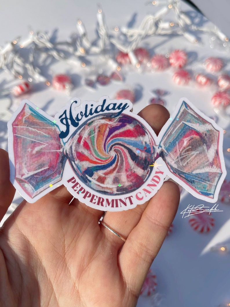 Może przedstawiać: Kolorowa naklejka z miętowym cukierkiem z napisem "Holiday Peppermint Candy" i wzorem w postaci spirali. Naklejka znajduje się na białym tle.