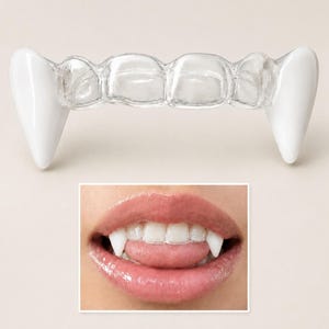 May include: White plastic vampire fangs with a clear plastic retainer. The image also shows a close-up of a person's mouth with the fangs in place, showcasing the product's appearance when worn. Perfect for Halloween or costume parties.