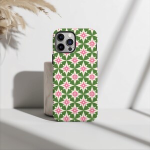 May include: A green and pink phone case with a geometric pattern of stars. The case is designed for an iPhone.