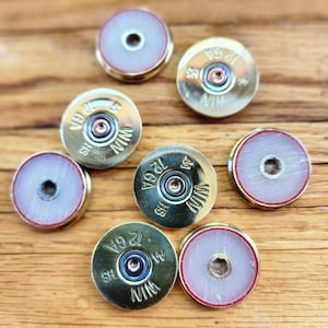 12 gauge shotgun shell head stamp rounds (slices).
