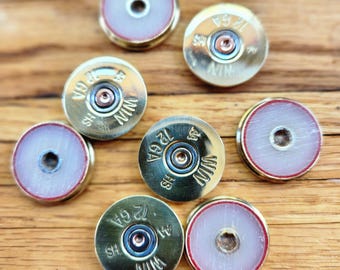 12 gauge shotgun shell head stamp rounds (slices).