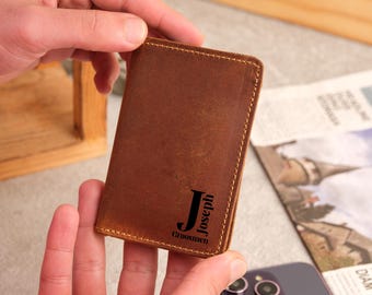 May include: A brown leather wallet with a personalized initial "J" and the name "Joseph" with the word "Groomsmen" underneath.
